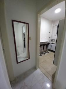 a mirror on a wall in a room at Apartamento mobiliado prédio frente ao mar in São Vicente