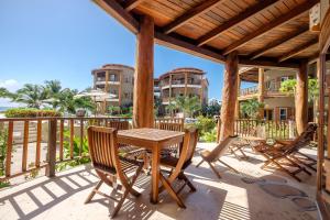 a wooden table and chairs on a patio at Three-Bedroom Apartment in San Pedro