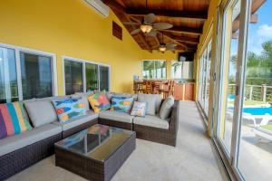 a living room with a couch and a table at Casa De Bonita Home in San Pedro