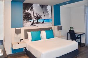 een slaapkamer met een bed en een bureau met een schilderij bij Suites Home 118 By SHG in Bogota