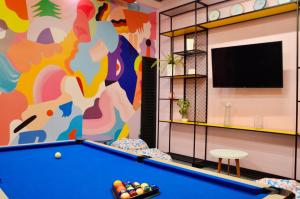 a pool table in a room with a mural at Suites Home 118 By SHG in Bogotá