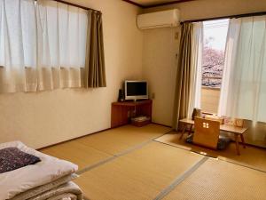 A bed or beds in a room at Tamaki Ryokan