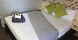 a bed with two pillows on top of it at Alfa motel in Gilgandra