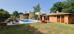 a backyard with a swimming pool and a house at Sunny Garden Villa with Pool in Loborika