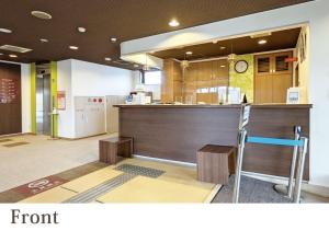 a kitchen with a counter and a bar with a chair at Forest Inn Gobo in Gobo