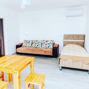 a living room with a couch and a table and a bed at Xanbulan İstirahət Mərkəzi in Lankaran