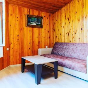 a living room with a couch and a table at Xanbulan İstirahət Mərkəzi in Lankaran