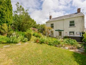 an old house with a garden in front of it at Garden Cottage in Bideford