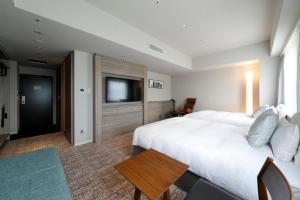 Postel nebo postele na pokoji v ubytování Glocal Hotel Itoshima