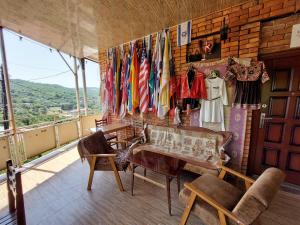 a room with a table and chairs and flags at Nato & Lado in Sighnaghi