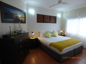 
a bedroom with a large bed and a large window at Compass Point 8 in Hamilton Island
