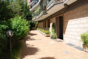 a brick walkway next to a building with plants at Residenza Flaminia in Rome