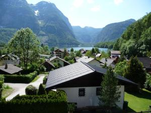 a village with a lake and mountains in the background at Haus Salzkammergut in Obertraun