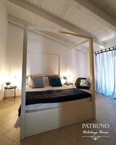 a bedroom with a canopy bed in a room at Patruno holidays house in Castellana Grotte