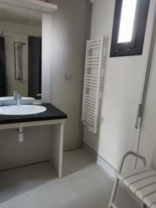 a bathroom with a sink and a mirror at ACS in Bagnols