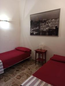 A bed or beds in a room at La casa di Mimì... calore e accoglienza!