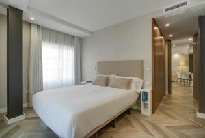 a bedroom with a large white bed in a room at San Sebastian Suites in Cartagena