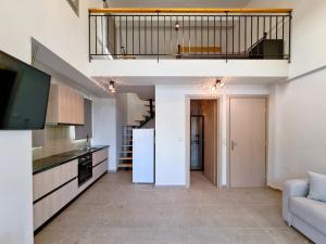 a kitchen with a white refrigerator and a living room at Sivota Apartment in Syvota