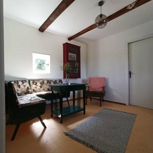 a living room with a table and a couch at Dada House Nature Holiday in Gornja Čemernica