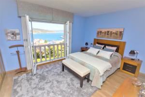 ein Schlafzimmer mit Bett und Balkon mit Aussicht in der Unterkunft Hospedium Galitrips Vila Maruja Corme in Corme-Puerto