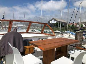 a table and chairs on a boat in a marina at La Vedette Hollandaise in Étaples +23 photos