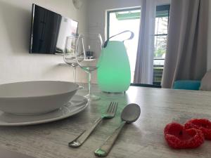 a table with a bowl and two glasses and two hearts at Las Mimosas Beach Sol in Puerto del Carmen
