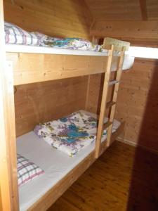 two bunk beds in a room with a ladder at Haukedalen Hytter in Viksdalen