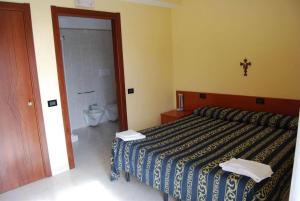 Postel nebo postele na pokoji v ubytování Hotel Il Chierichetto