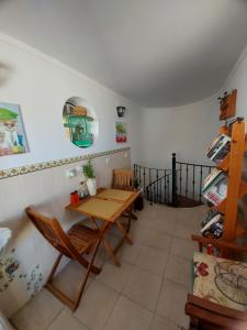 a dining room with a table and a chair at Guest House Capitao Mor in Faro