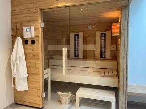 a bathroom with a glass shower stall with a sink at Alpenchalet Iseler in Oberjoch