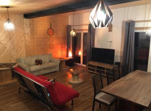 a living room with a couch and a table at Villa Alma Arlberg in Warth am Arlberg