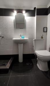 a bathroom with a white toilet and a sink at Nearby the sea in Asprovalta +14 photos