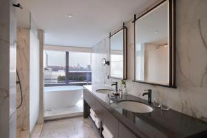a bathroom with two sinks and a bath tub at Grand InterContinental Seoul Parnas by IHG in Seoul +168 photos