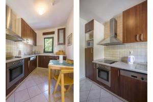 une cuisine avec des placards bruns et une table. dans l'établissement VERY NICE TWO BEDROOM APARTMENT in IVANICA near DUBROVNIK - C, à Ivanica