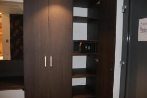 a closet with wooden cabinets and a microwave at LH Boardinghouse GmbH - wi Dahaam in Küps