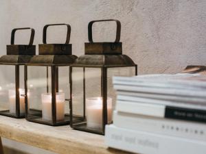 two candle holders on a table with books at Locanda San Silvestro - Meride in Mendrisio