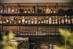 a bar with lots of bottles of alcohol on shelves at Hotel Plaza in Pag