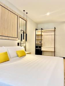 a bedroom with a large white bed with yellow pillows at Soho Boutique Córdoba in Córdoba +68 photos