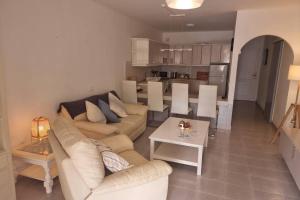 a living room with a couch and a table at Casa Gales: Relax next to the Sea Apartment for Families in Corralejo