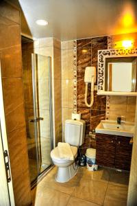 a bathroom with a toilet and a shower and a sink at Sky Alremu Apart Hotel in Side