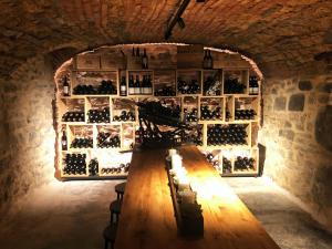 a wine cellar with a wooden table and a wall of wine bottles at Locanda San Silvestro - Meride in Mendrisio