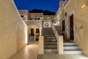 a staircase leading up to a house at night at Chez Sophie in Kamari