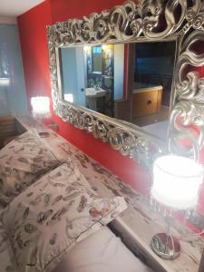 a bedroom with a large mirror on the wall at Hotel Boutique Real Posada De Liena y Restaurante Liena in Murillo de Gállego