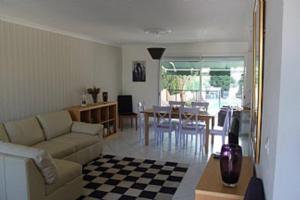 a living room with a couch and a table at Holiday Home With Pool In Marseillan in Marseillan