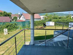 a balcony of a house with a view of a yard at Apartmán TRIGA in Snina