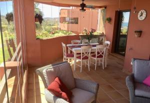 a dining room with a table and chairs on a patio at El Patio de Doña Julia in Bahia de Casares