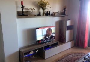 a flat screen tv sitting on a stand in a living room at El Patio de Doña Julia in Bahia de Casares