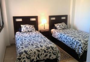two beds sitting next to each other in a bedroom at El Patio de Doña Julia in Bahia de Casares +37 photos