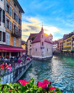 a view of a river with buildings and a church at LPA in Annecy