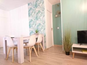 a dining room with a white table and chairs at LPA in Annecy